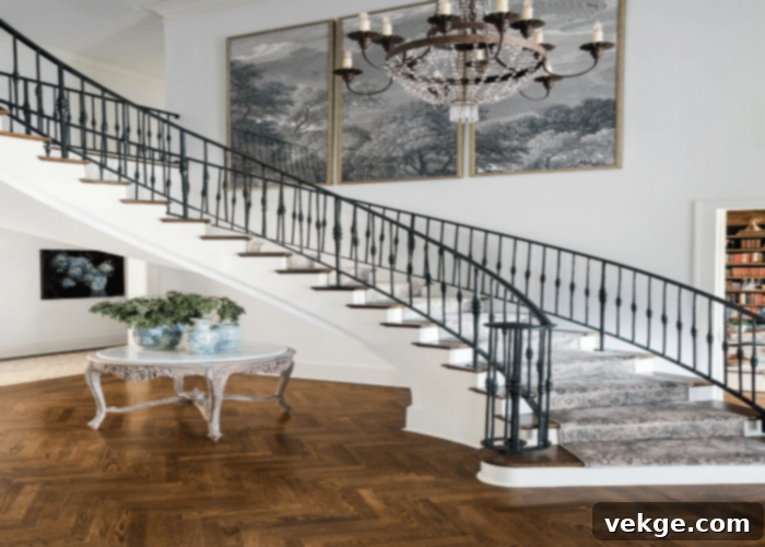 Grand staircase featuring an oversized abstract wall art piece and an elegant chandelier, creating a luxurious and artistic focal point