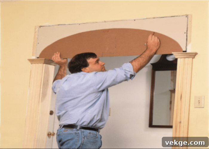 Removing an existing door frame and marking the new arch outline on the wall