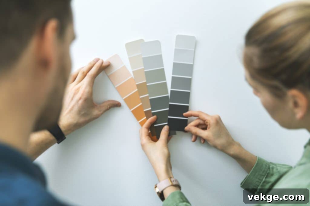 young couple choosing paint color from samples for new home interior design