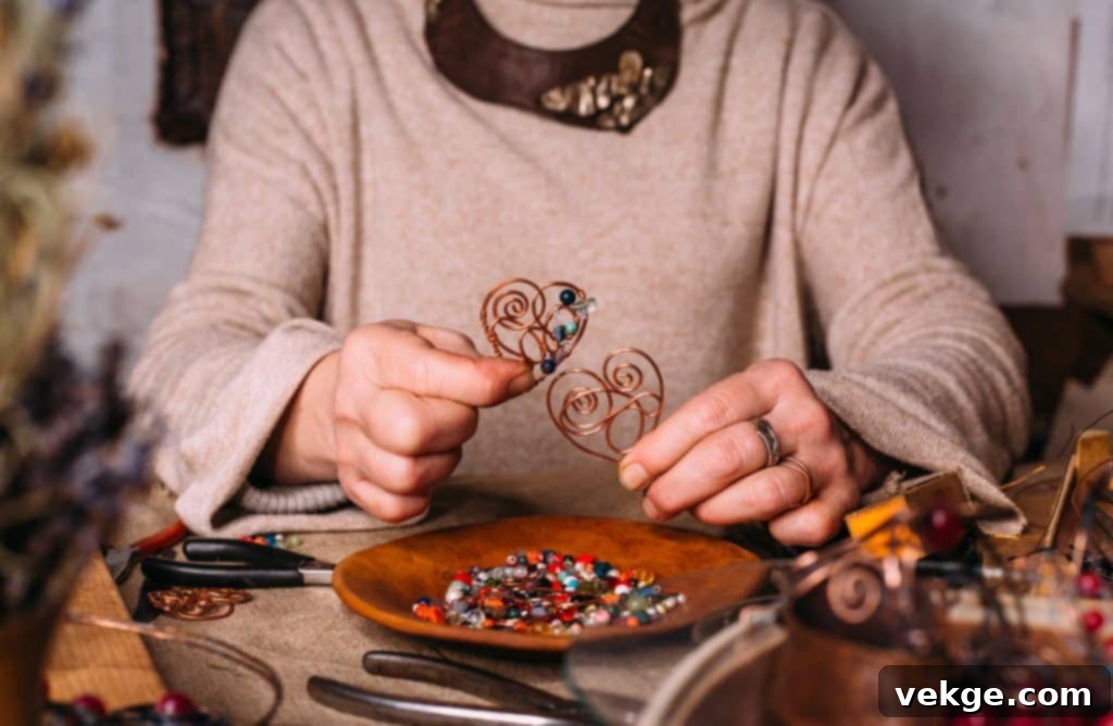 working process making jewelry for wire wrapped bijouterie. real process. craft handmade copper wire working tools on the table with accessoires. handicraft people art concept