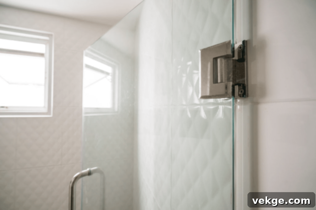 Elegant hinged glass shower door opening outwards.