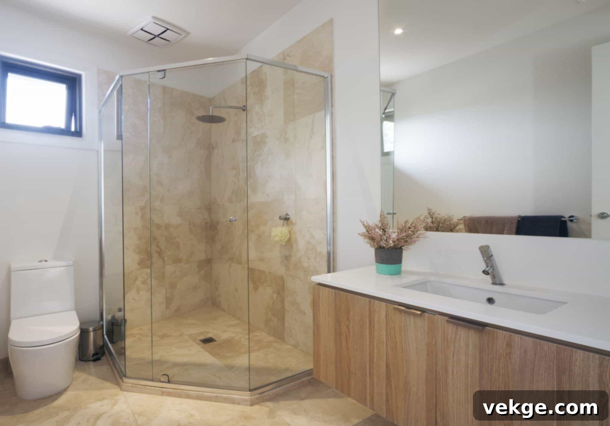 Stylish neo-angle glass shower door in a corner bathroom setup.
