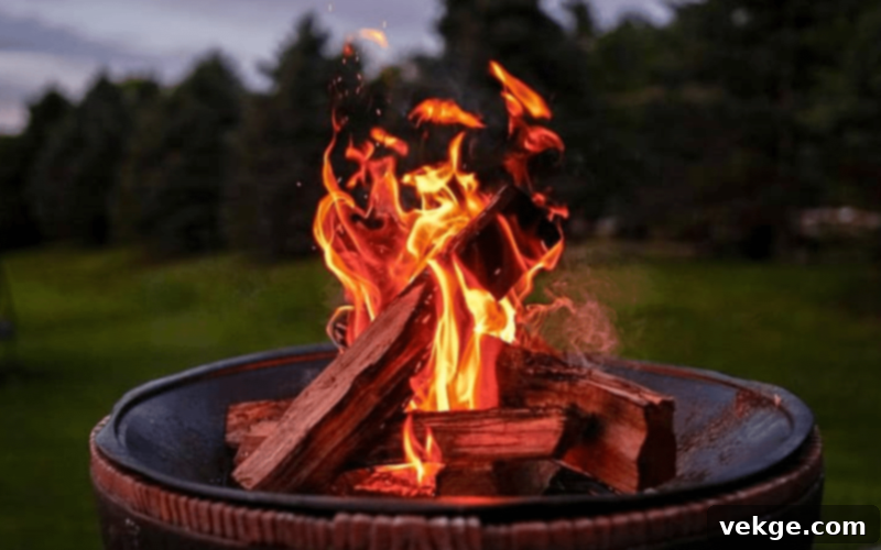Crackling fire pit fueled by seasoned wood, casting a warm glow on an outdoor patio