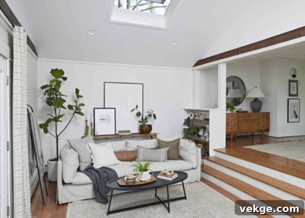 A cozy living room with a couch, coffee table, and an elegantly treated ceiling