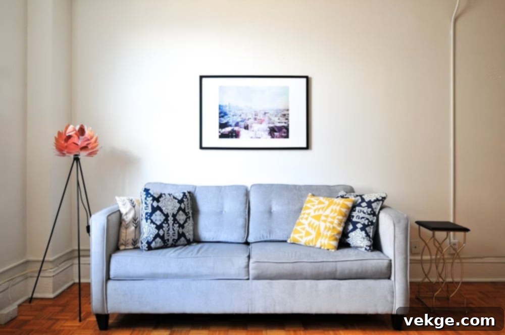 A chic blue fabric couch in a contemporary living room, highlighting the importance of inspecting care labels and hang tags.