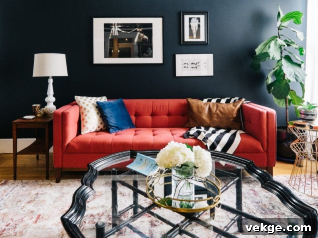 Navy blue walls with a red sofa creating a sophisticated and balanced living space