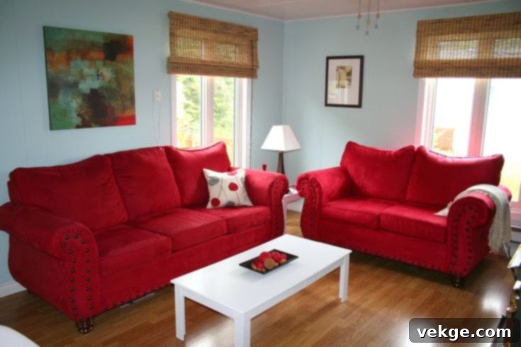 Light blue walls offering a serene backdrop for a red sofa to glow