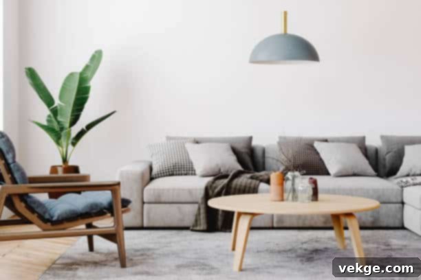 Modern living room setup with classic parquet floor. Furnished with light gray sofa, blue arm chair with wooden frame, modern blue ceiling lamp, wooden coffee table and gray carpet.
