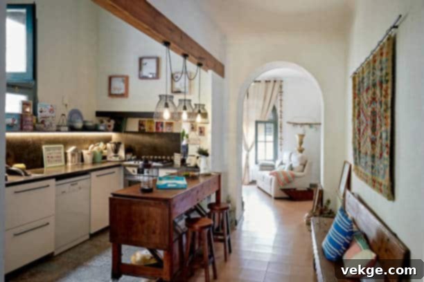 Wide angle view of kitchen with wooden counter-height dining table and stools, hanging light fixtures, bench, and view into living room, showcasing statement lighting.