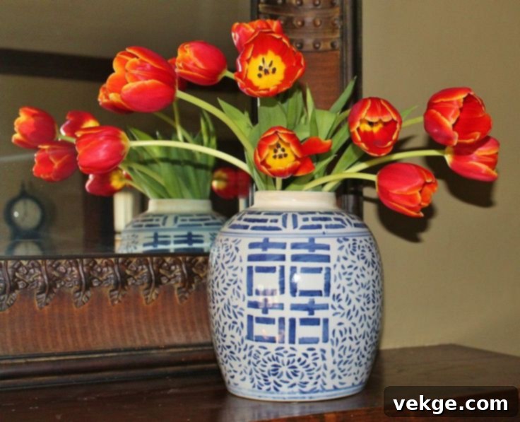 Vibrant colorful tulips arranged beautifully in a striking ginger jar, adding a modern touch to decor