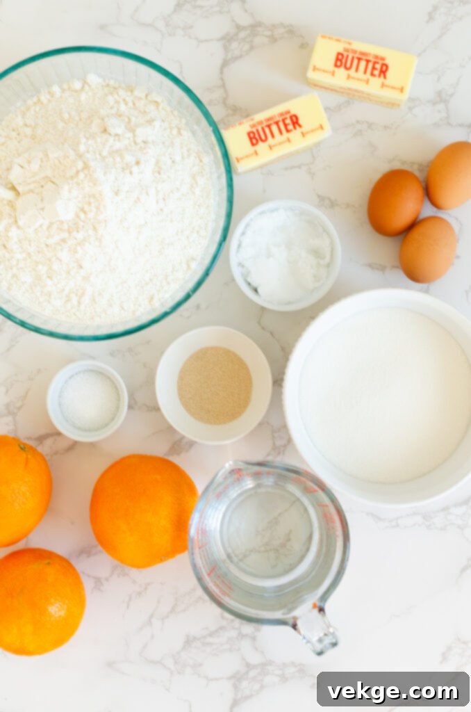 Sweet Orange Swirls 3 Close-up of an orange roll, showing its soft, swirled interior and shiny orange glaze.