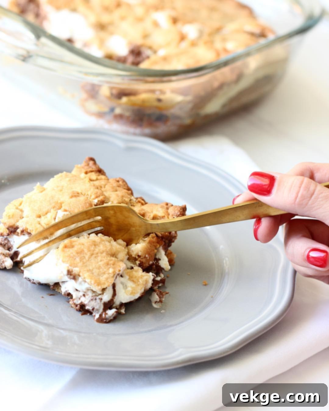 Gooey Smores Bars 2 Delicious S'Mores Bars cooling on a wire rack after baking, showing golden brown marshmallow and rich chocolate layers.
