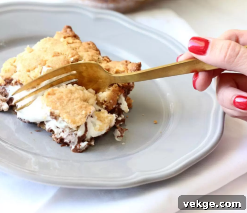 Gooey Smores Bars 4 A perfectly baked s'mores bar, cut into squares and ready to serve, showcasing the gooey layers.