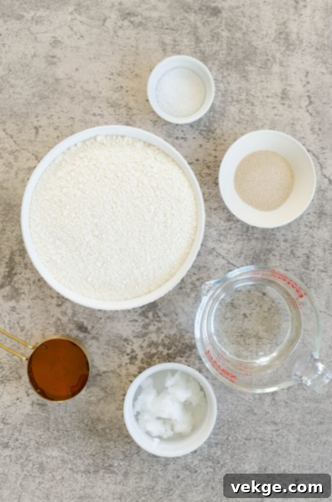 Close-up of a stack of soft dinner rolls on a wooden board.