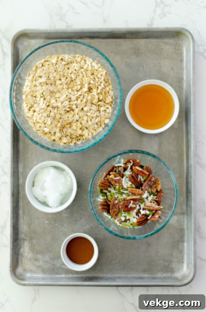 Cozy Cinnamon Granola 3 Ingredients for homemade cinnamon granola laid out on a baking sheet