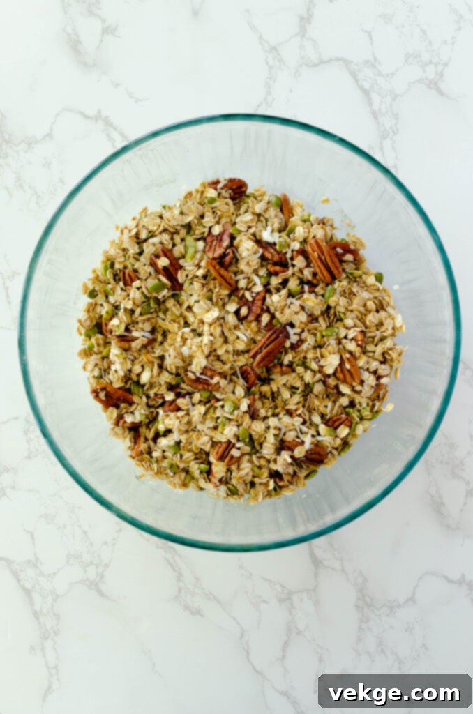 Cozy Cinnamon Granola 4 Close-up of raw homemade cinnamon granola mixture on a baking sheet before baking