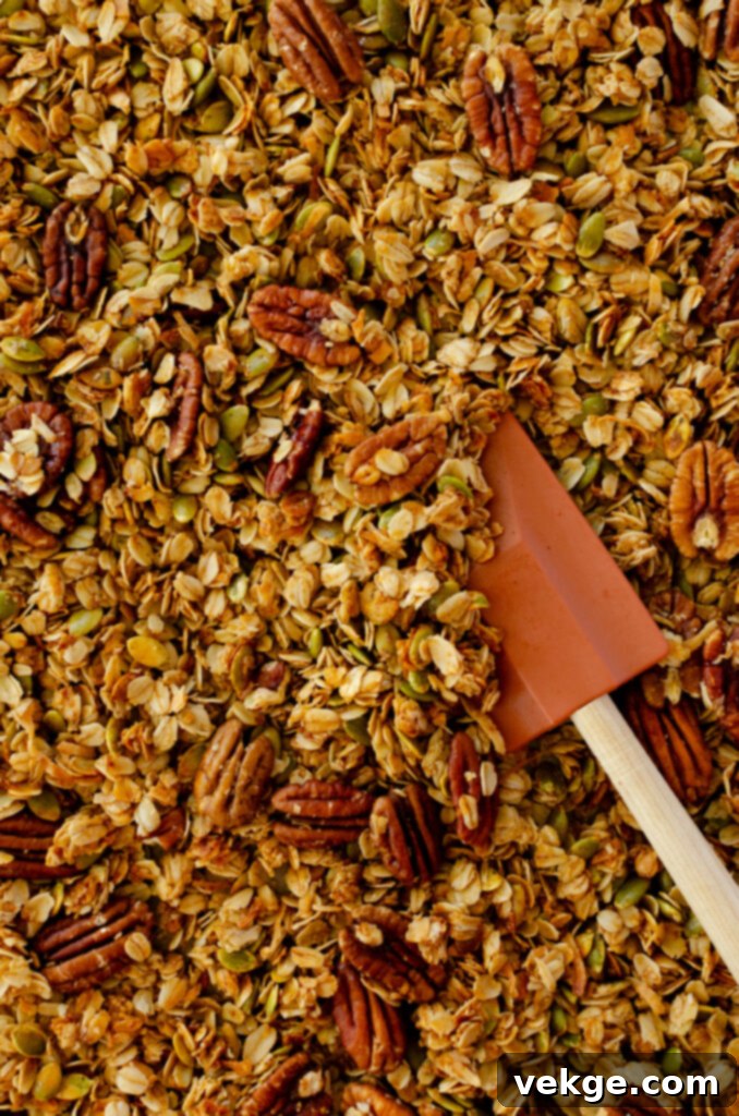 Cozy Cinnamon Granola 8 A bowl of homemade cinnamon granola with berries and yogurt