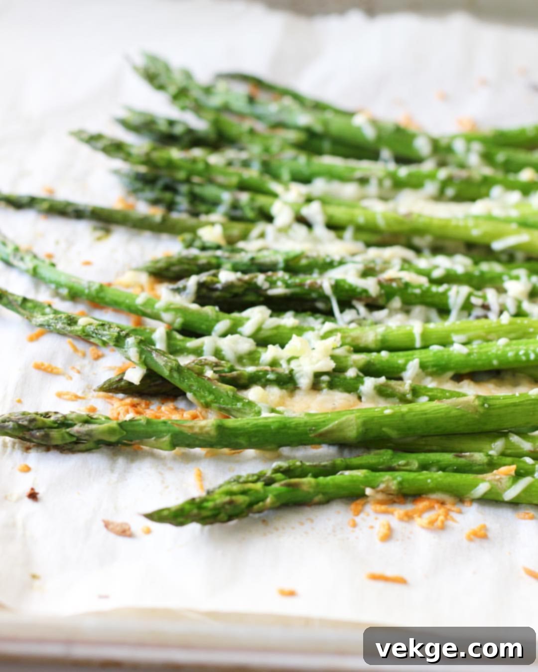 Roasted Parmesan Garlic Asparagus 2 Freshly roasted Parmesan Garlic Asparagus on a baking sheet, ready to serve