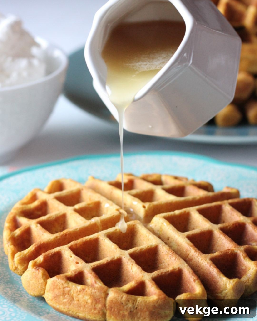 Golden Pumpkin Waffles with Creamy Buttermilk Syrup 2 A stack of freshly made pumpkin waffles generously drizzled with golden buttermilk syrup, garnished with a sprinkle of cinnamon and fresh berries.