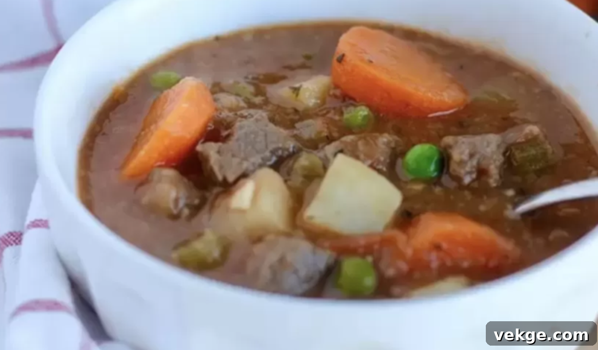 Comforting Beef Stew 4 Hearty Beef Stew served in a bowl, garnished with fresh herbs.