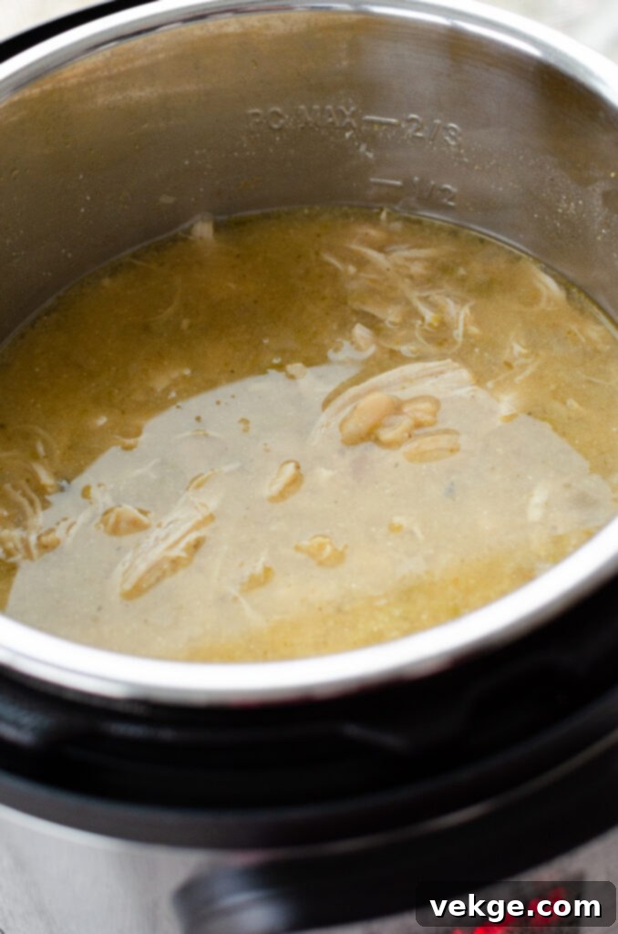 Creamy Instant Pot White Chicken Chili 3 Close-up of diced onions and minced garlic ready for sautéing in an Instant Pot.