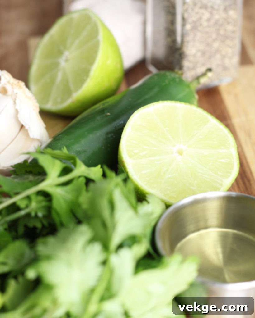 Verdant Heat Vinaigrette 2 Fresh cilantro, jalapenos, and limes on a wooden board, ready for making the dressing.