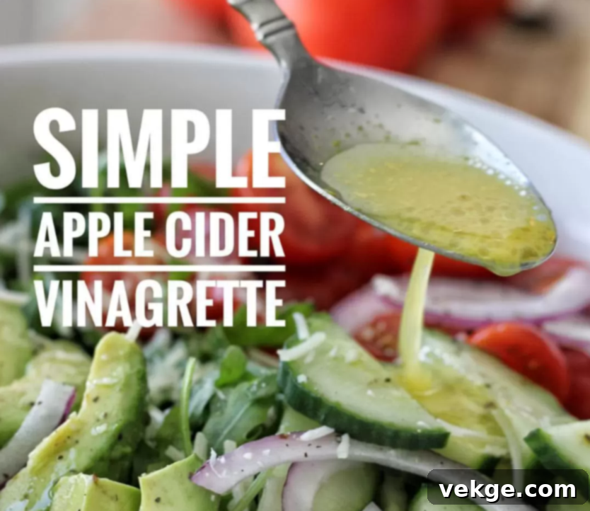Simple Apple Cider Vinaigrette A vibrant, fresh salad generously drizzled with homemade apple cider vinaigrette, highlighting its deliciousness and healthy appeal.