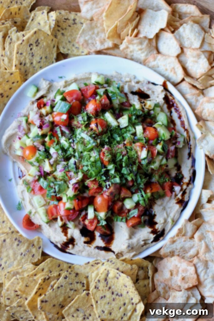 Close-up of fresh vegetables topping hummus