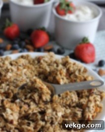 Toasted Coconut Almond Granola 3 A close-up of a serving of coconut almond granola, highlighting the flakes and clusters.