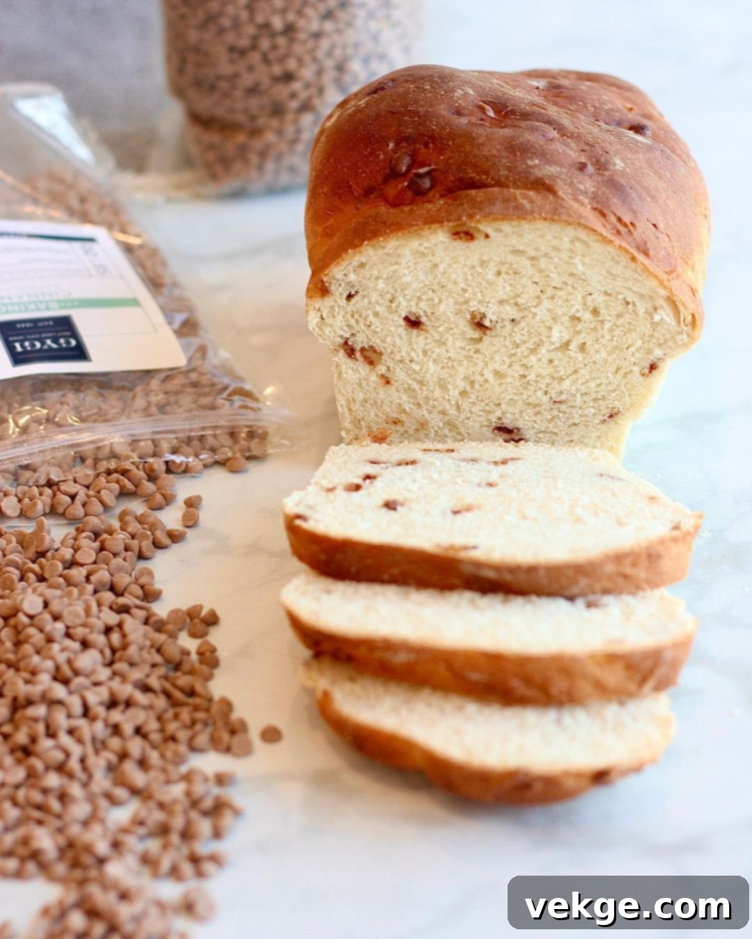 Cinnamon Swirl Bread 2 A freshly baked loaf of golden-brown cinnamon white bread, warm and ready to be sliced, sitting on a cooling rack.