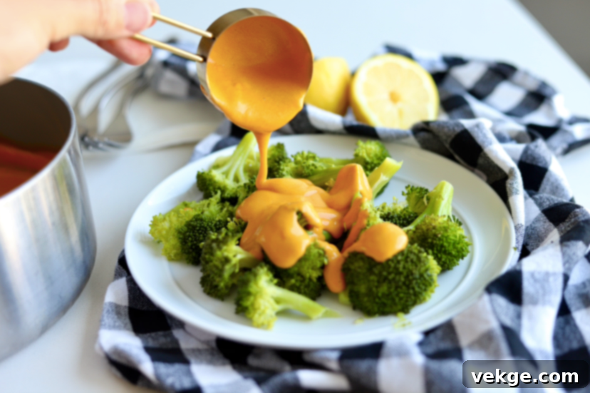 Creamy Vegan Cheese Sauce 4 A bowl of creamy vegan cheese sauce ready to be served, garnished lightly.