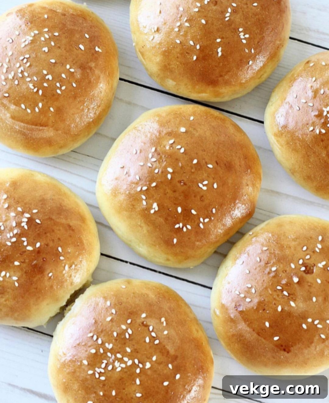 Artisan Burger Buns 2 Freshly baked homemade hamburger buns cooling on a wire rack.