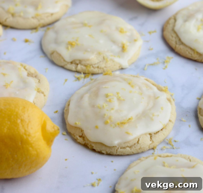 Sunshine Lemon Delights by Kate 6 A stack of freshly baked lemon cookies with white chocolate ganache frosting.