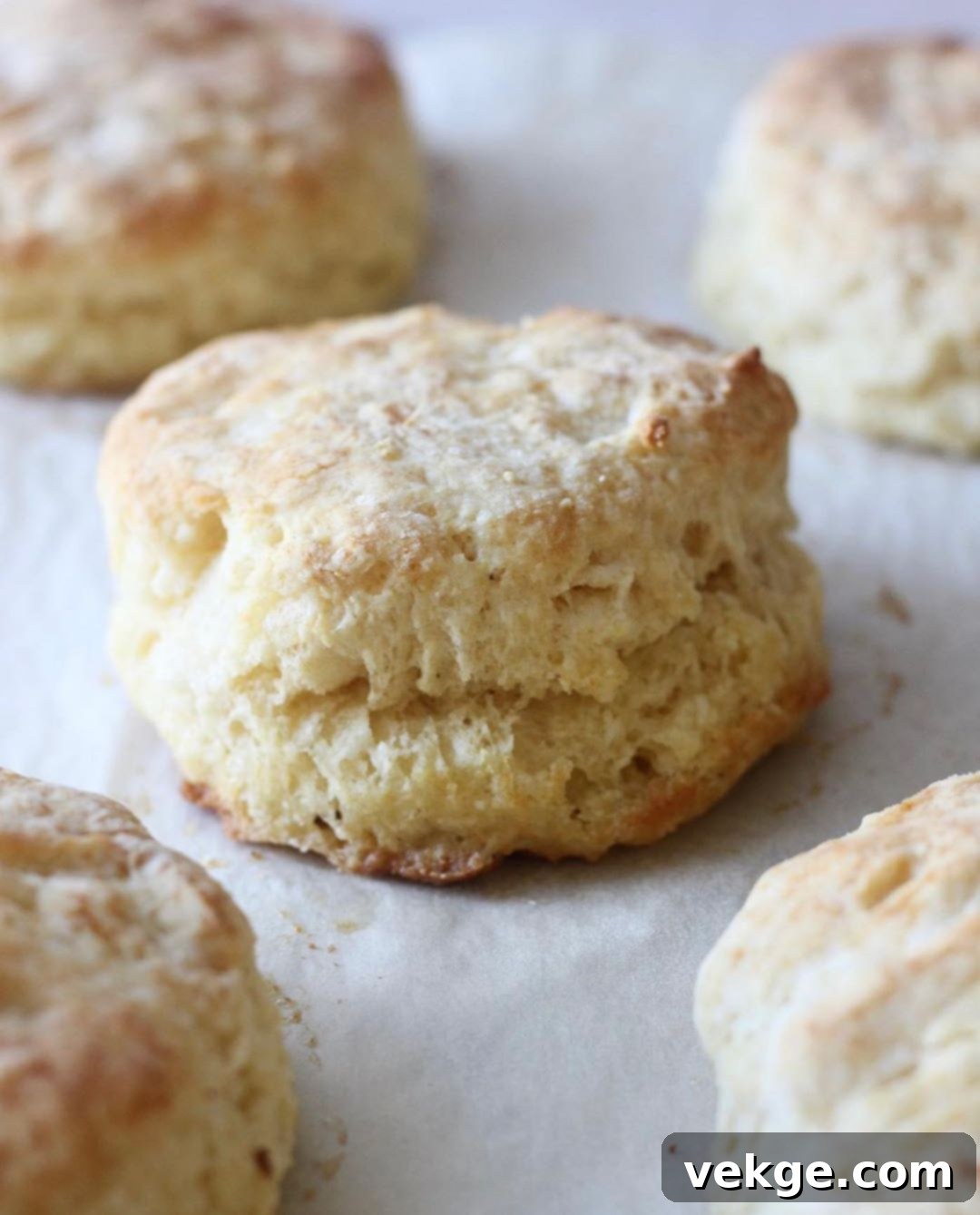 Unbelievably Fluffy Homemade Biscuits 2 Golden brown, flaky homemade biscuits stacked on a cooling rack, ready to be served.