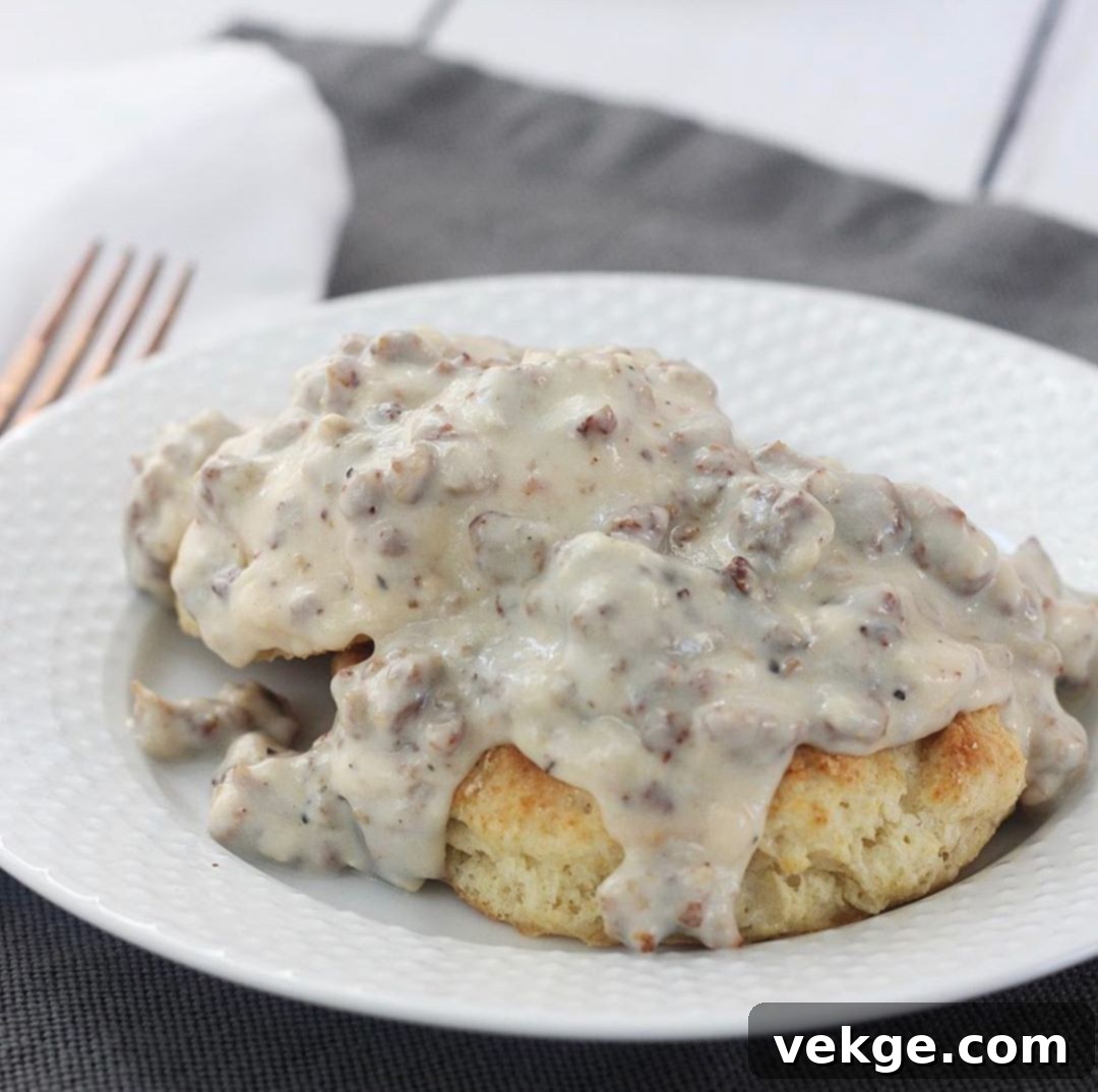 Mind-Blowing Sausage Gravy 4 A bowl of creamy, homemade sausage gravy with bits of browned sausage visible, perfect for topping biscuits.