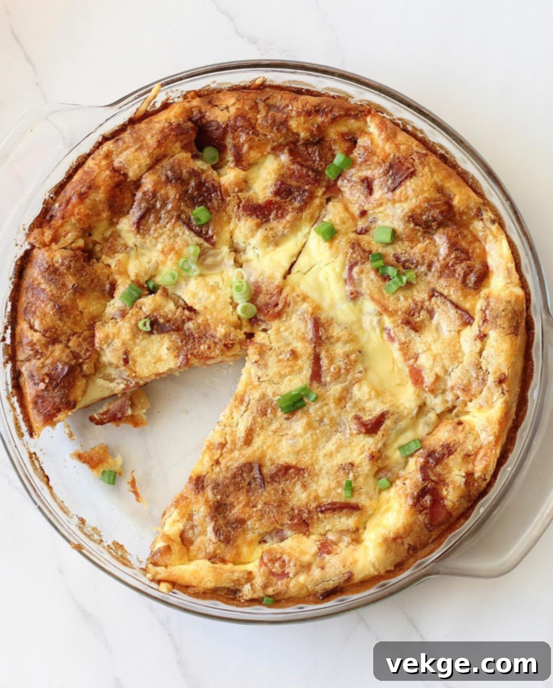 Hearty Bacon and Swiss Quiche 2 A delicious slice of crustless bacon and Swiss quiche on a plate, ready to be enjoyed.