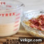 Hearty Bacon and Swiss Quiche 5 A close-up of the egg, milk, flour, and salt mixture being blended for a smooth custard.