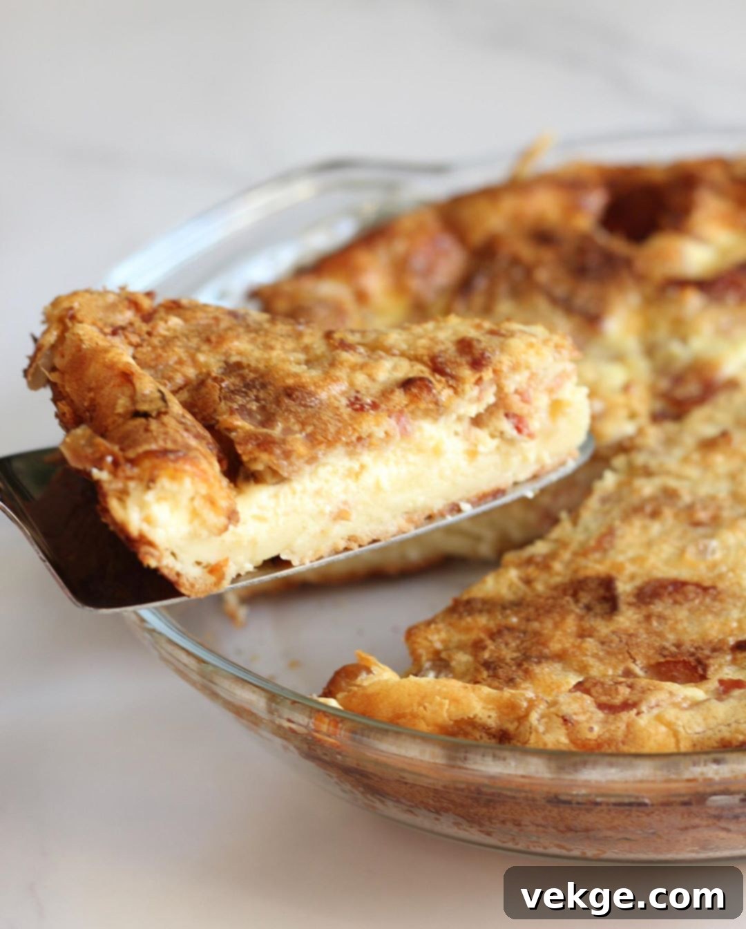 Hearty Bacon and Swiss Quiche 9 A serving of crustless bacon and Swiss quiche with a fork, ready to be eaten.