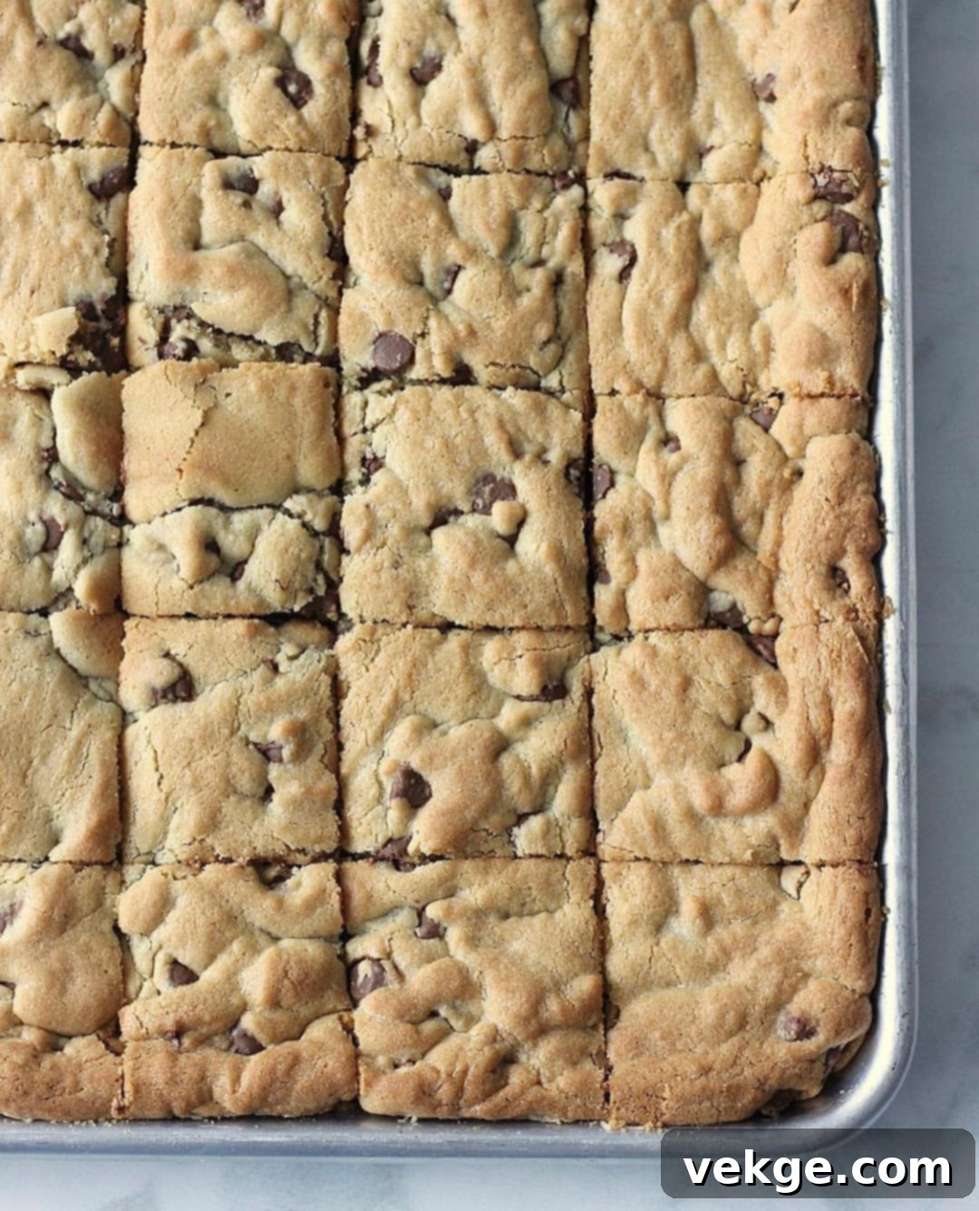 Ultimate Chocolate Chip Cookie Bars 2 Deliciously baked chocolate chip cookie bars, golden brown and chewy, ready to be sliced