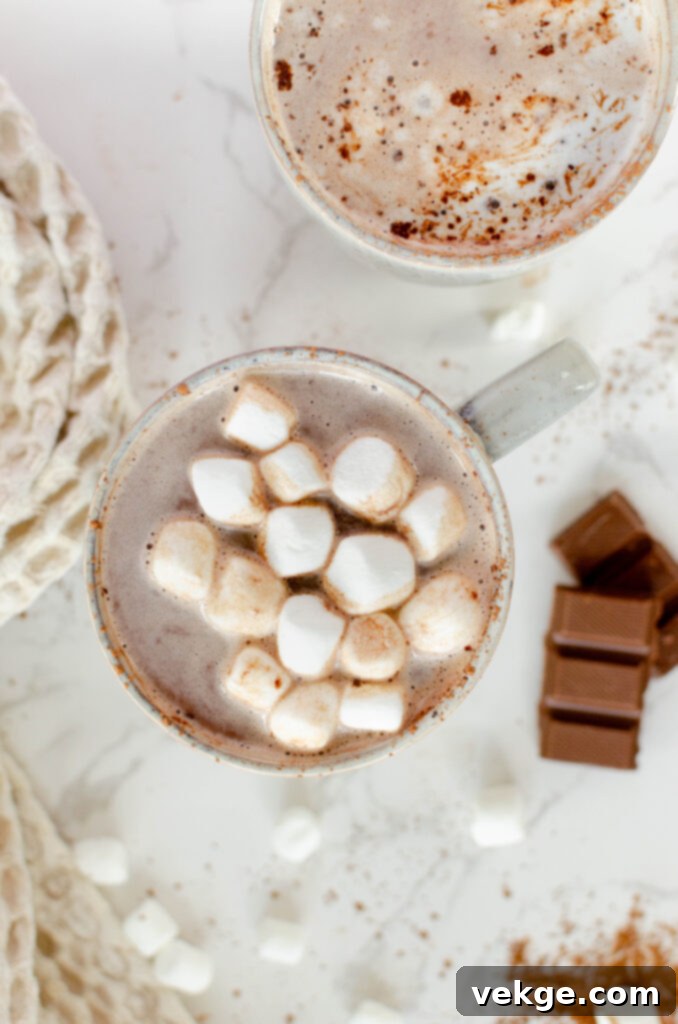 A cozy scene with a mug of hot chocolate, a book, and warm blankets, inviting relaxation.