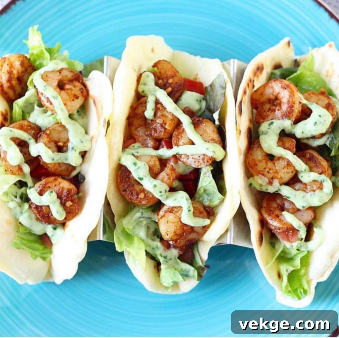 Chili Lime Garlic Shrimp Tacos, Avocado Cloud 3 Close-up shot of seasoned Chili Lime Shrimp cooking in a frying pan.