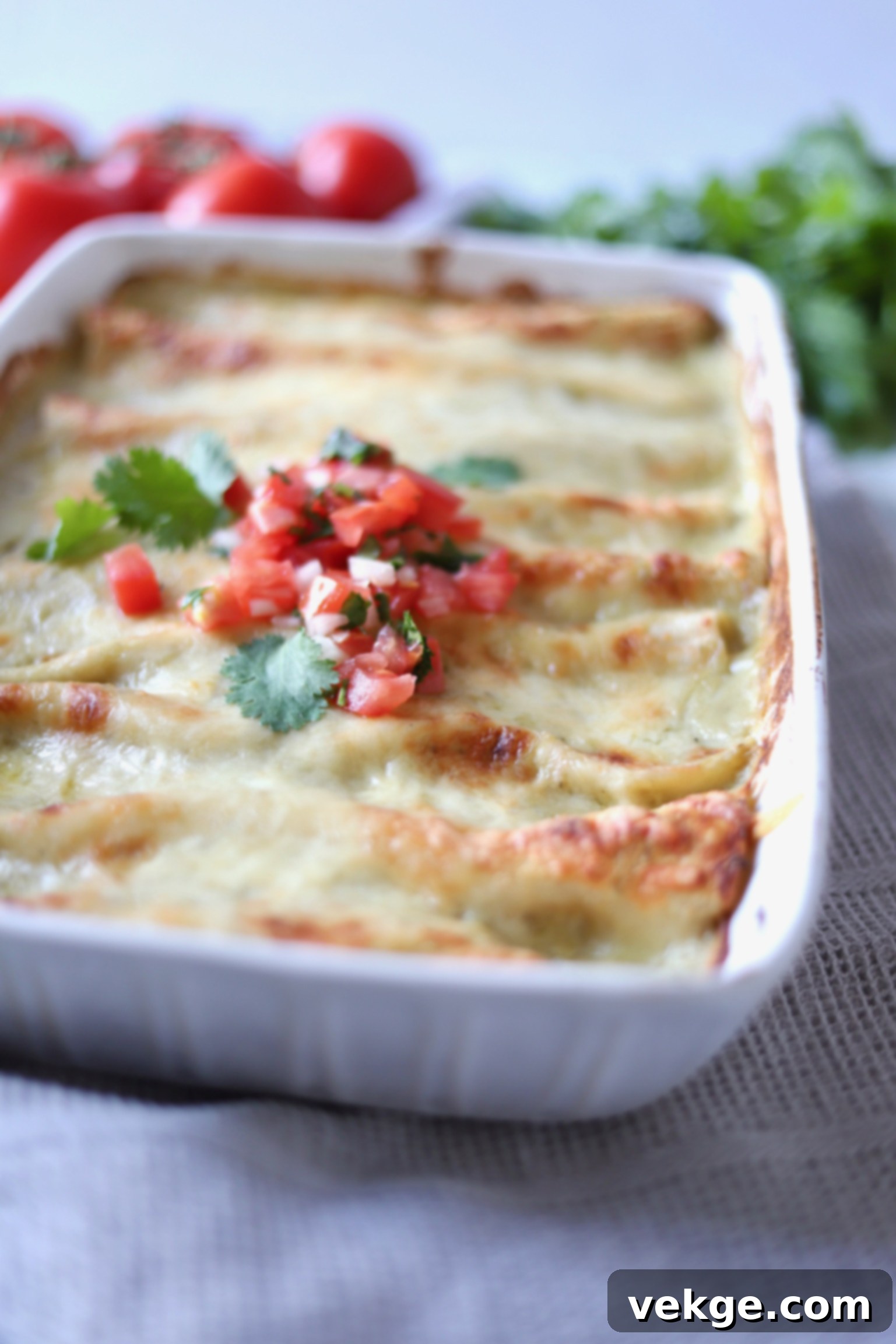 Ultimate Chicken Enchiladas 2 Delicious creamy chicken enchiladas in a baking dish