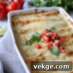 Ultimate Chicken Enchiladas 6 Close-up of baked chicken enchiladas topped with melted cheese