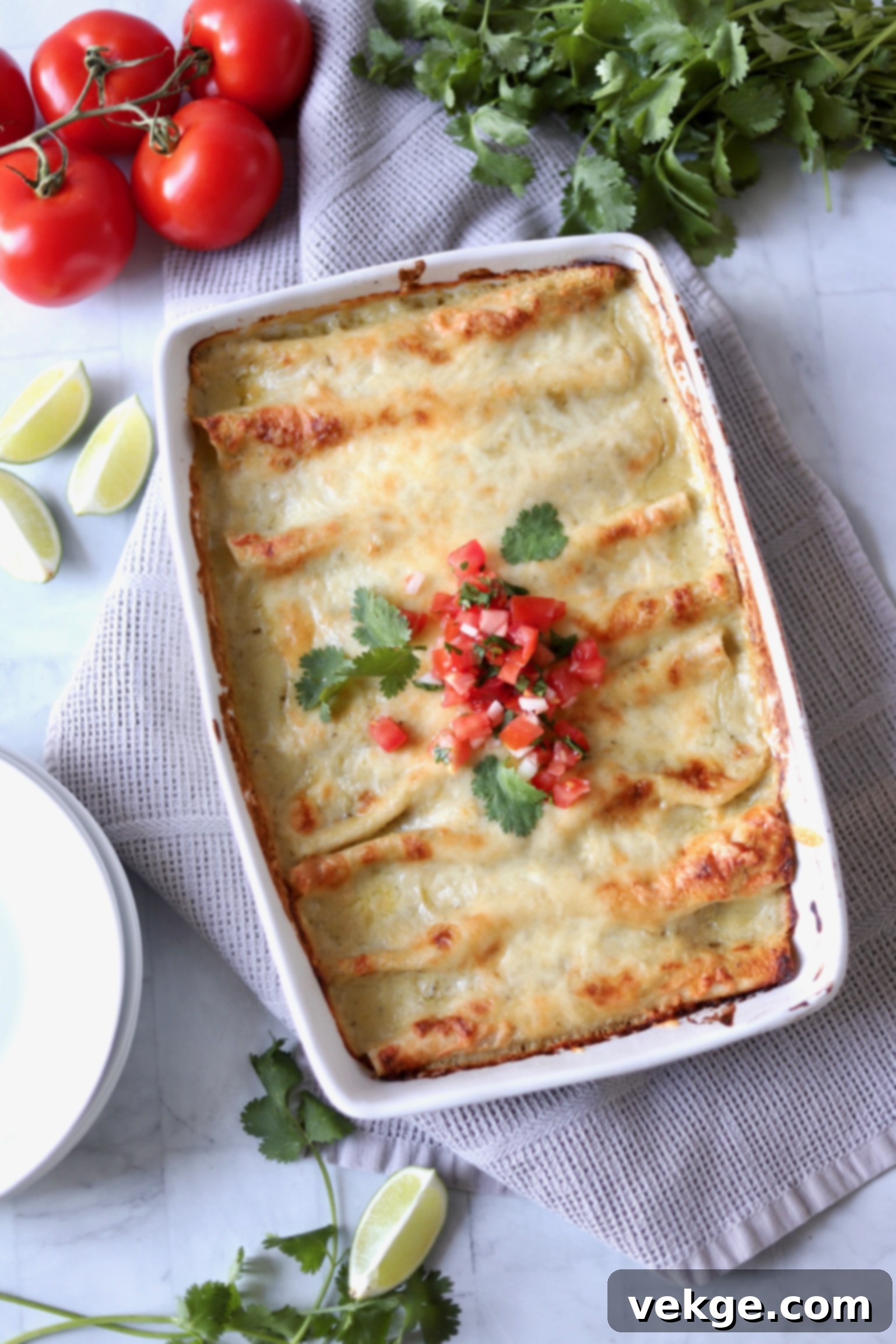 Ultimate Chicken Enchiladas 7 A baking dish filled with finished creamy chicken enchiladas