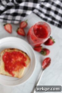 Effortless Strawberry Bliss Freezer Jam 4 Ingredients for strawberry freezer jam laid out: fresh berries, pectin, and jars