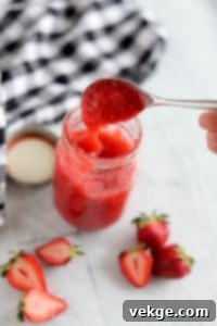Effortless Strawberry Bliss Freezer Jam 5 Mashing fresh strawberries for the freezer jam recipe, showing a rustic texture