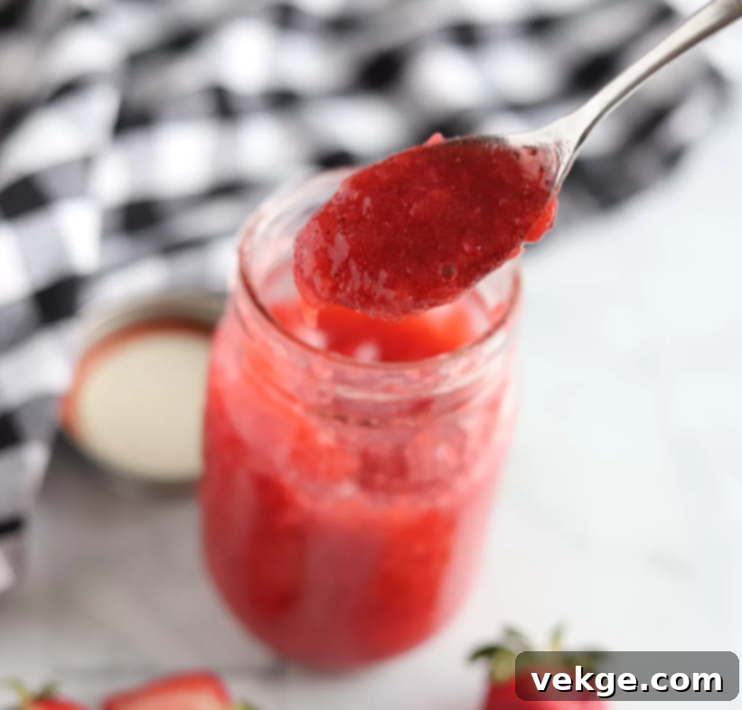 Effortless Strawberry Bliss Freezer Jam 6 A jar of homemade strawberry freezer jam, showcasing its vibrant color and fresh appearance.