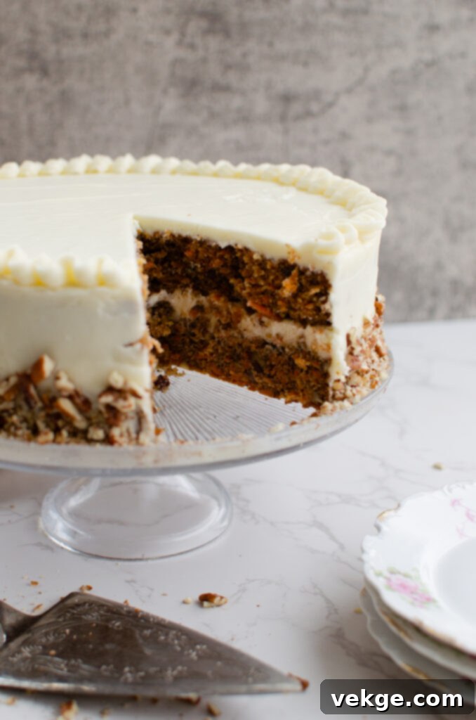 Detailed close-up of the smooth cream cheese frosting on a carrot cake