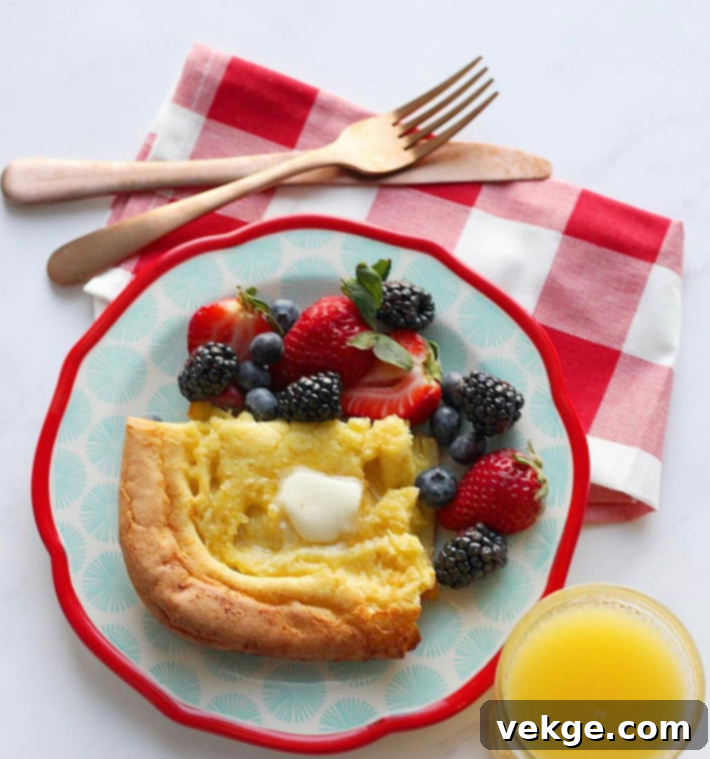 Oven-Baked German Delights 4 Close-up of a German Pancake, garnished with fresh berries and powdered sugar, ready to be served.