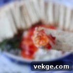 Sweet Heat Cheese Board 5 A container of organic ricotta cheese, highlighting its fresh and creamy texture.